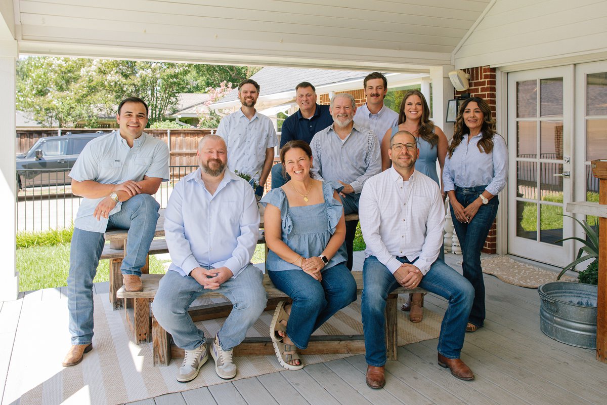The Todd Tramonte Home Selling Team sitting together on a covered porch