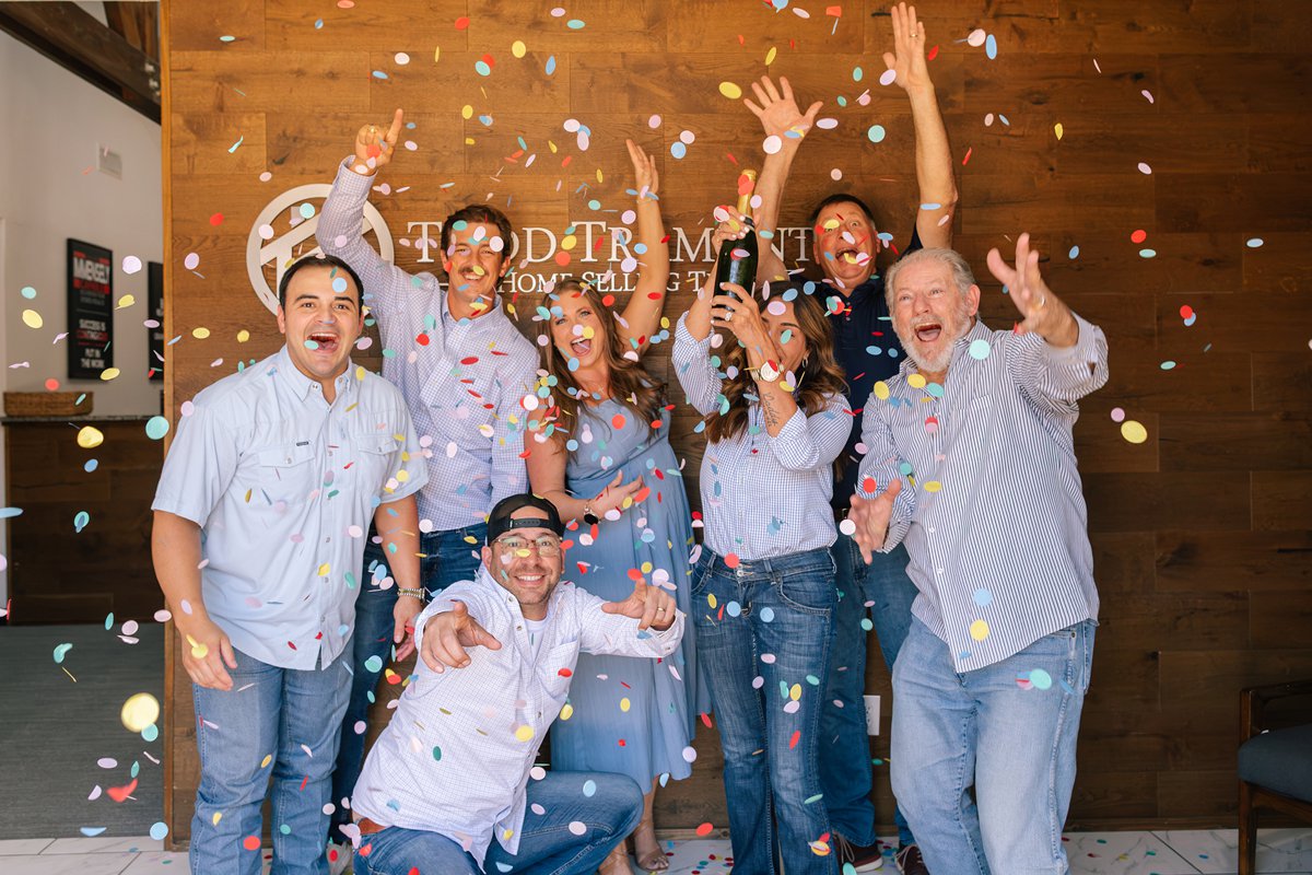 Todd Tramonte Home Selling Team members celebrating with confetti in the team office