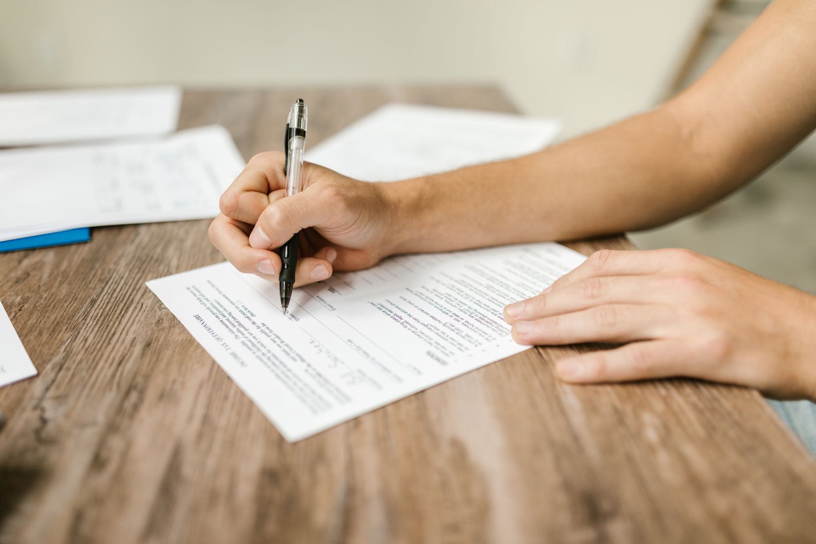 Home seller reviewing and signing disclosure paperwork at a table