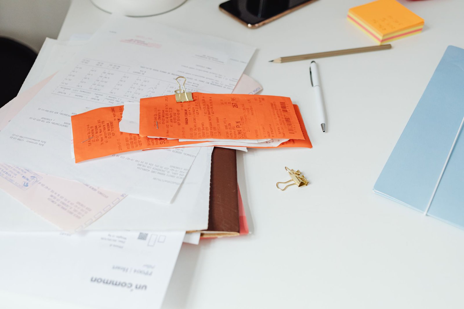 Home repair receipts and records spread on a table, ready for a seller's disclosure