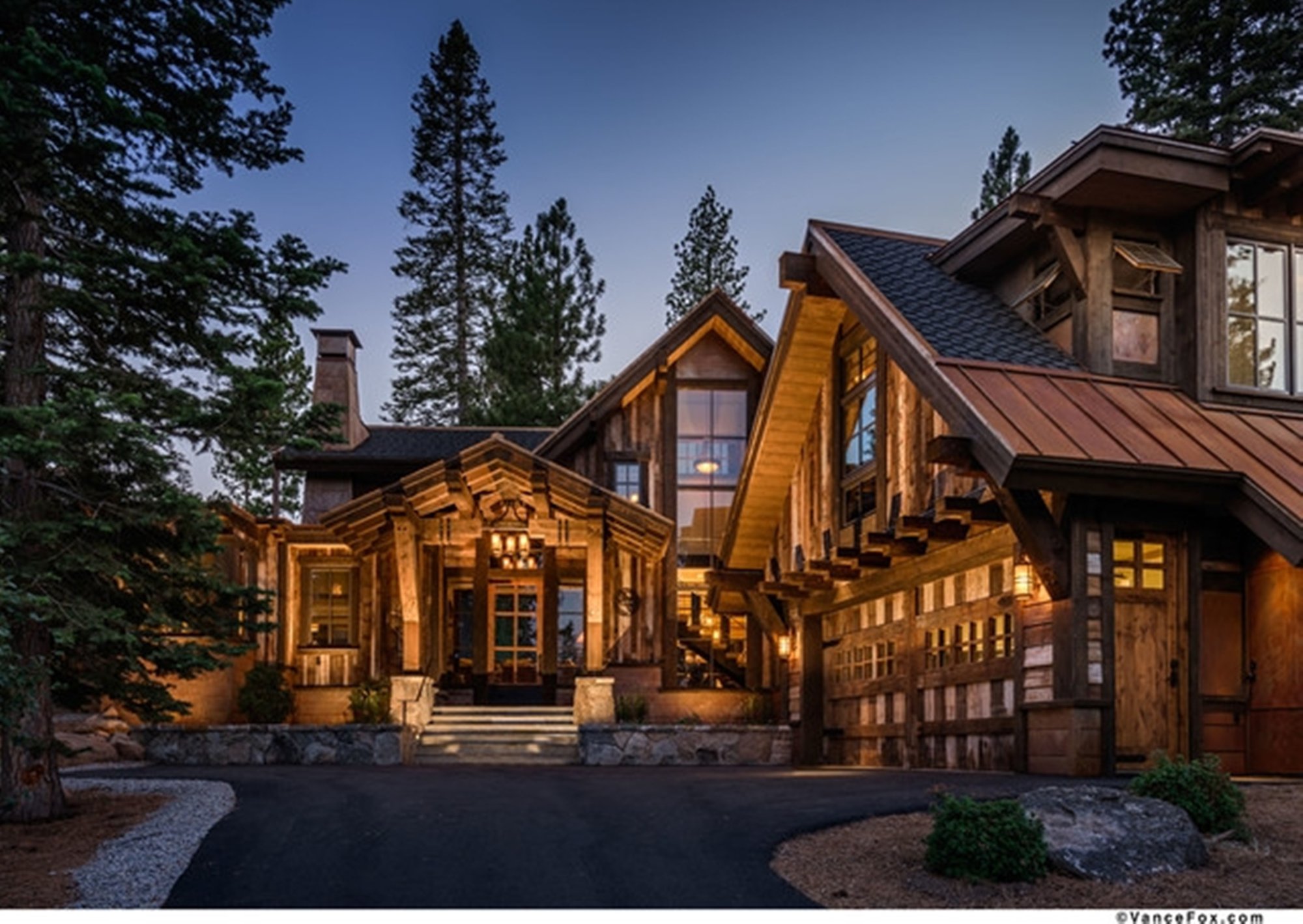 Log home glowing at dusk among the pines