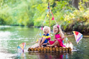 Sisters Cove with kids on raft in cove