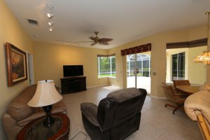 Long view of the family room with the lake in sight - 14124 Nighthawk Terrace - Lakewood Ranch