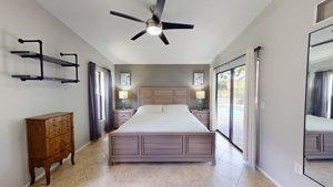 Primary bedroom with sliding-glass access to the pool area at 2461 Gold Oak Ct E
