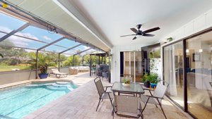 Screened lanai and pool connected to the living area at 2461 Gold Oak Ct E