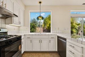 Kitchen with new stainless steel gas range and dishwasher at 19243 Dovewood Court