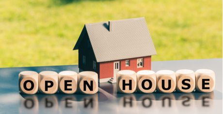 Tiny house with blocks spelling out Open House