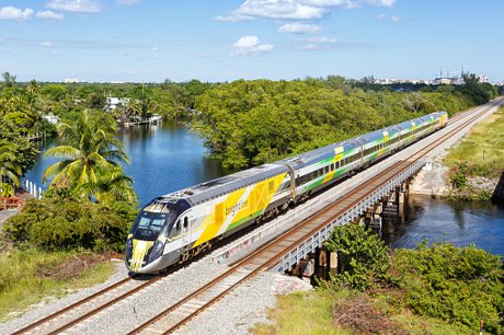 Brightline train departing Orlando International Airport at high speed in Central Florida