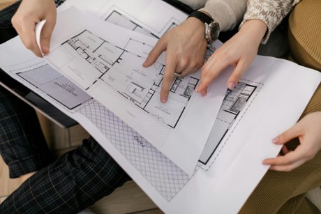People looking at sketches of a house project