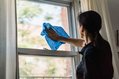 Woman cleaning a window