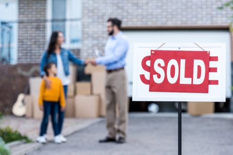 A real estate agent visiting with a new home buyer