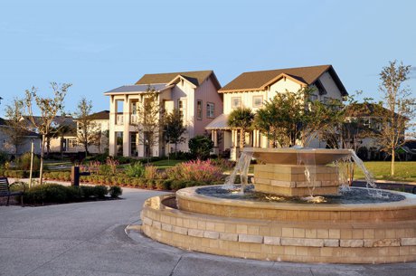 Crescent Park lawn and fountain surrounded by homes in Laureate Park, Lake Nona