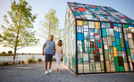 Glass House sculpture by Tom Fruin, colored plexiglass panels beside the lake in Laureate Park, Lake Nona