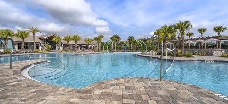 Resort-style pool with beach entry and shaded seating at the Storey Park amenity center