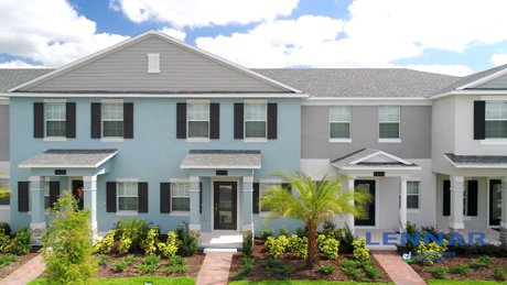 Row of two-story Storey Park townhomes with front porches and paver driveways