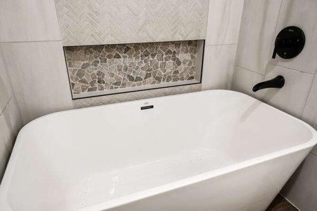 Space conscious rustic modern bathroom remodel with freestanding tub