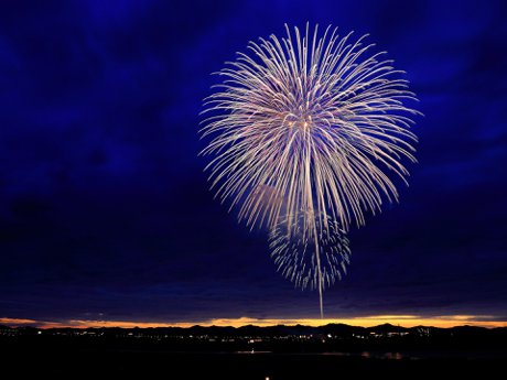 yellow fireworks over a town