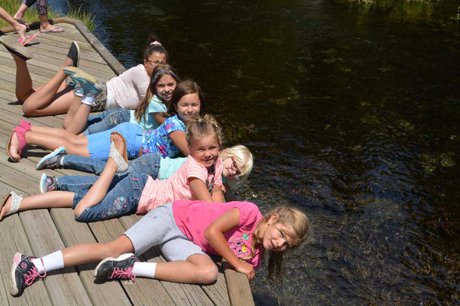 Image of children having fun in Island Park Idaho on the Big Springs doc near short term rental property