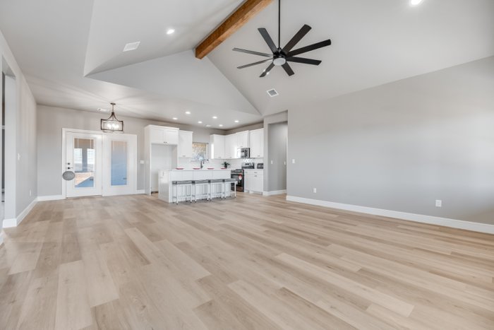 Open living area with ceiling fan