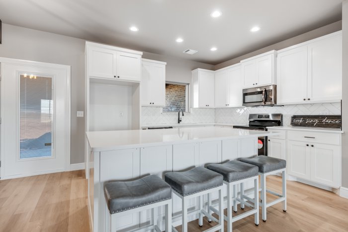 Kitchen with large granite island and bar seating