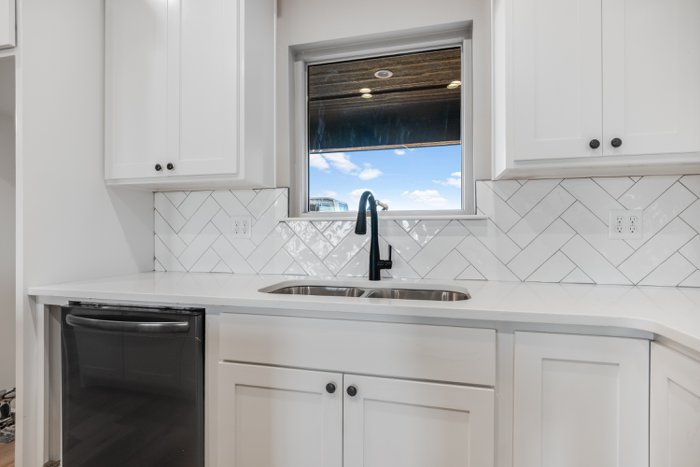 Kitchen sink and white cabinetry