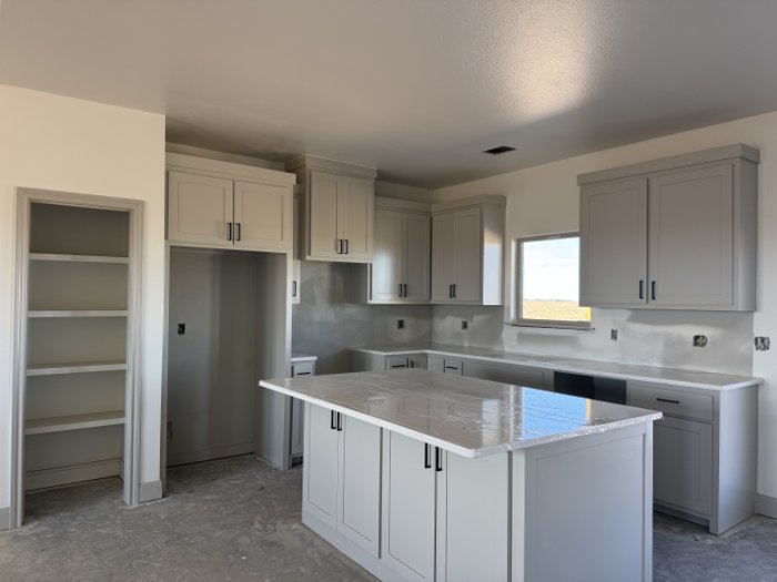 Sample photo: Kitchen island and walk-in pantry in the 1,738 sq ft plan