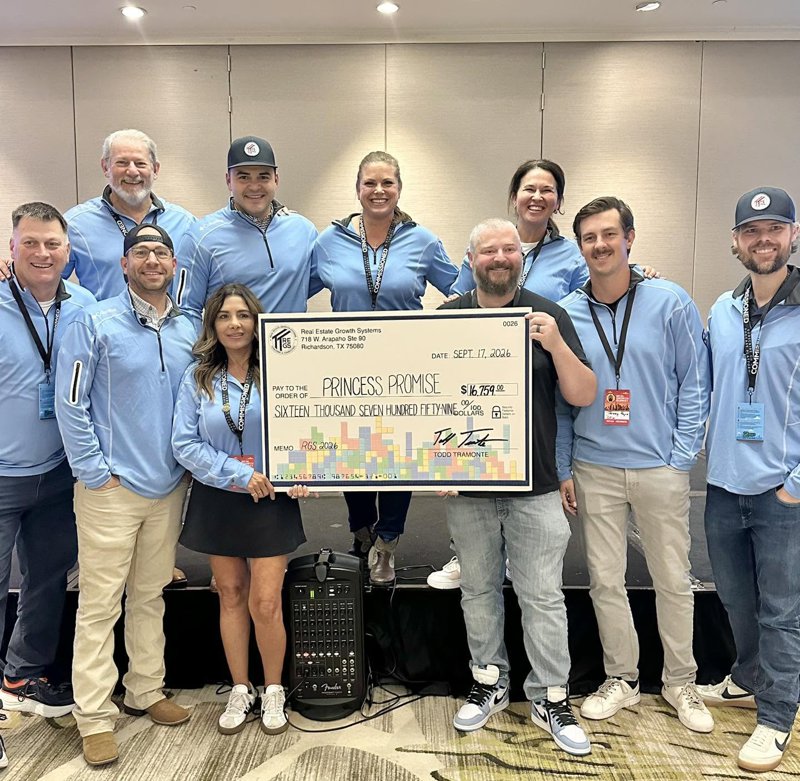 Team members holding a large donation check made out to Princess Promise