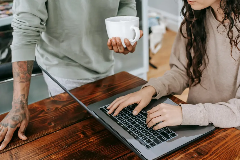 two looking at a laptop screen