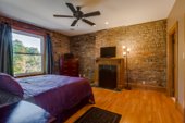 Master suite with exposed brick