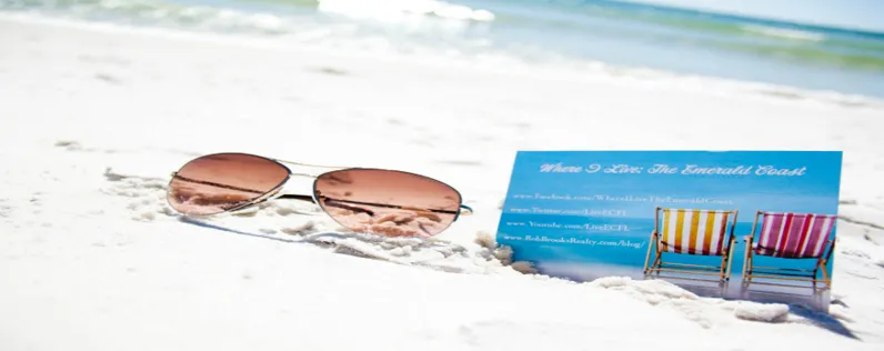 Sunglasses and Business Card in the sand