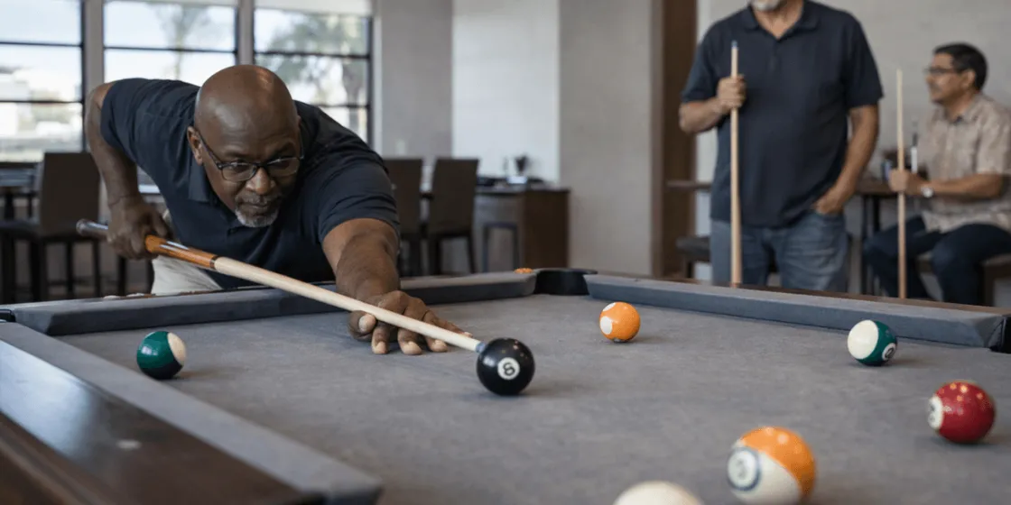 two people playing pool at a community clubhouse in a gilbert 55 + community