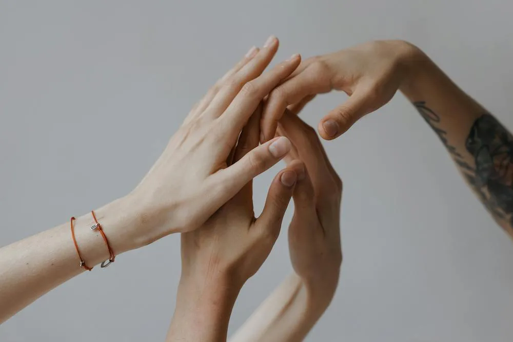 people putting their hands together