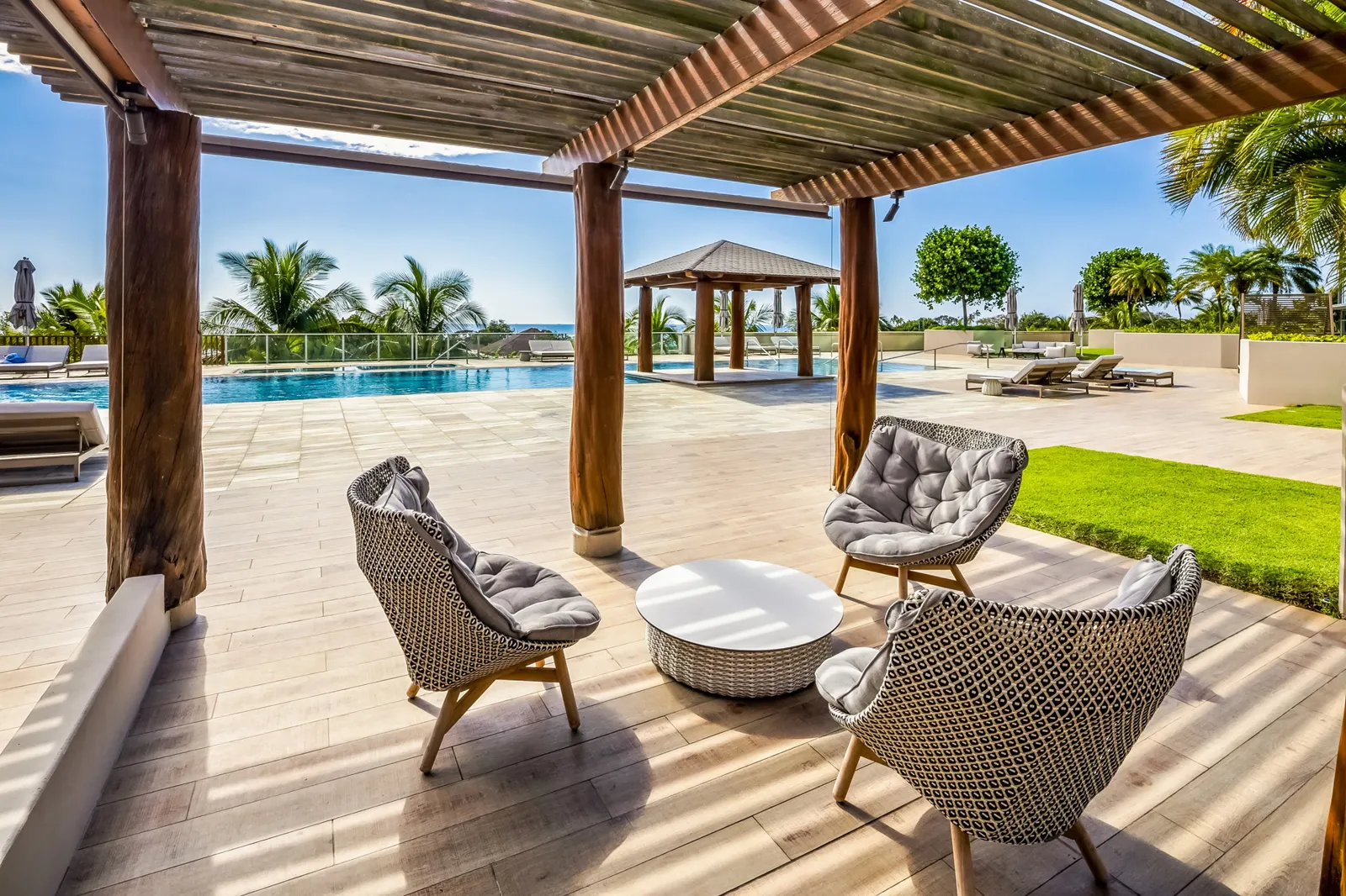 Covered seating and landscaped pool deck at Hokua condominium