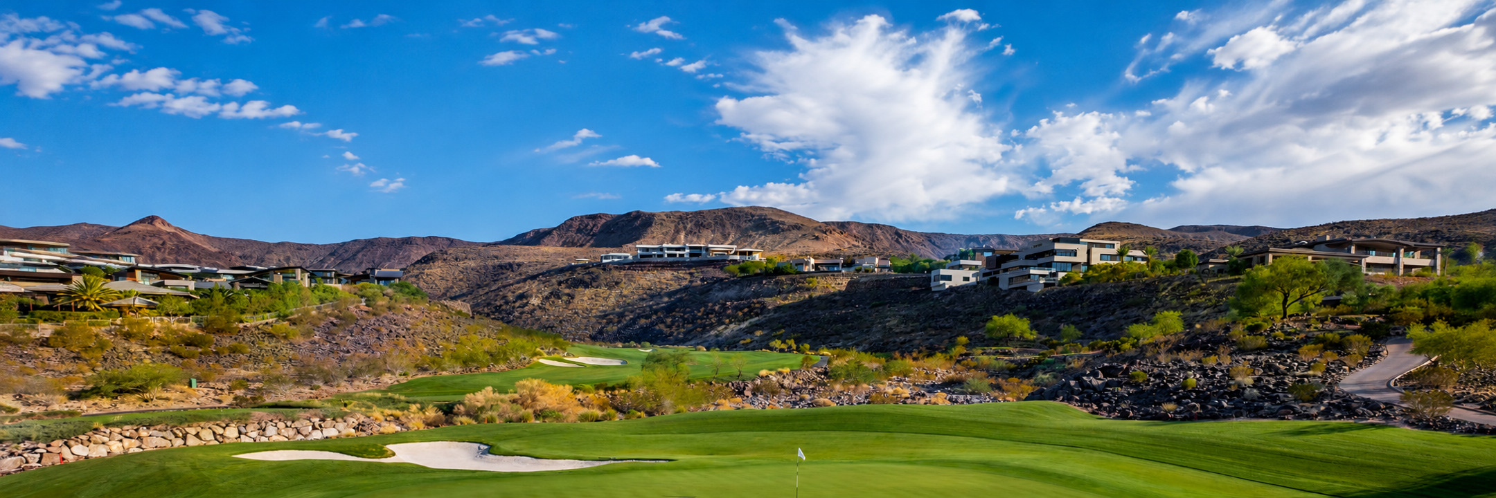 Luxury homes overlooking a golf course and desert mountains in the Las Vegas area